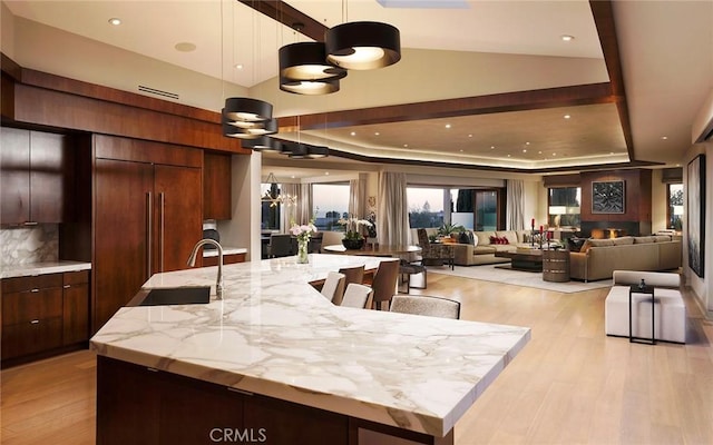 kitchen featuring a spacious island, pendant lighting, and a tray ceiling