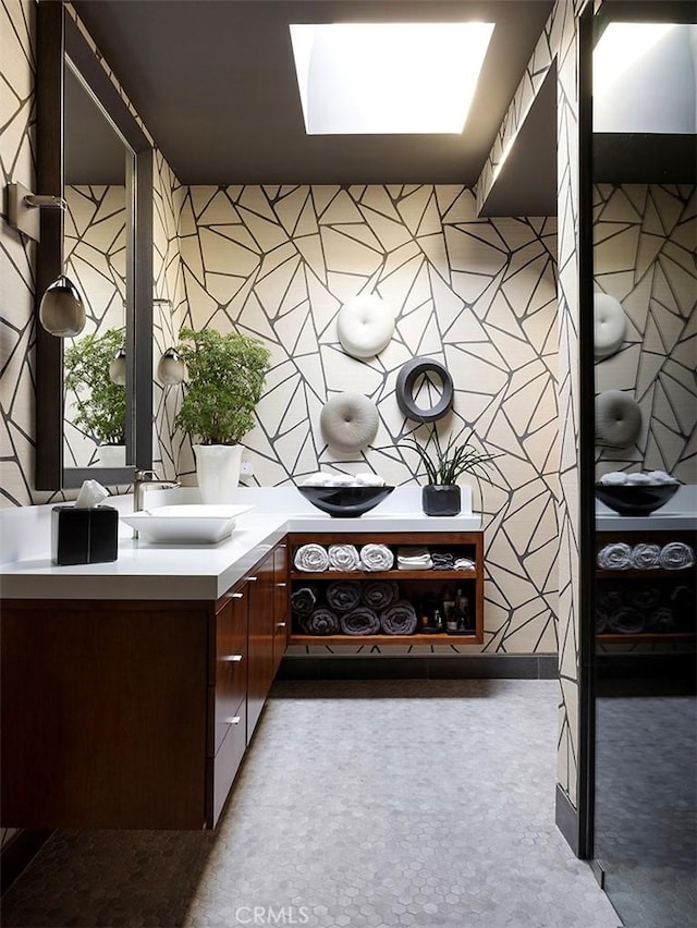 bathroom featuring vanity and a skylight