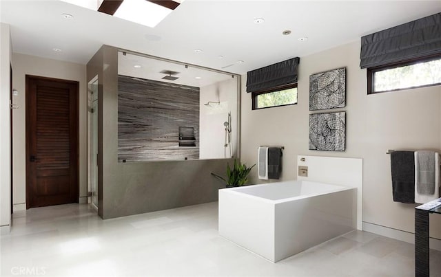 full bathroom with recessed lighting, a skylight, a bath, and walk in shower