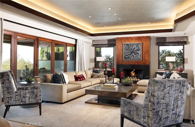 interior space with a large fireplace and a tray ceiling