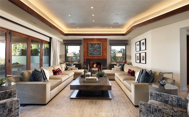 interior space with a raised ceiling and a fireplace