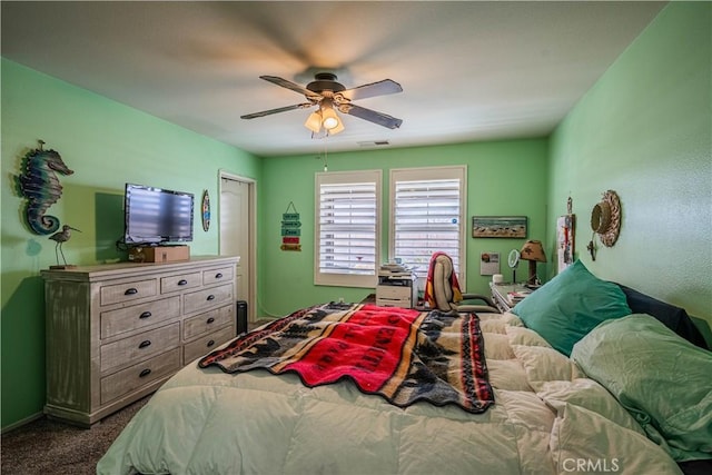 bedroom with dark carpet and ceiling fan