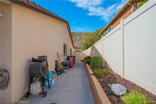 view of home's exterior featuring a patio area, a fenced backyard, a tile roof, and stucco siding