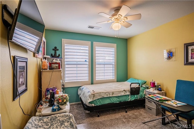 carpeted bedroom with ceiling fan and visible vents