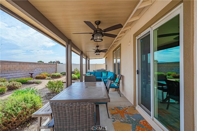 view of patio / terrace featuring a ceiling fan, a fenced backyard, and an outdoor living space