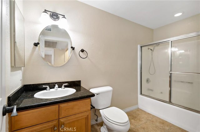 full bathroom with vanity, tile patterned floors, shower / bath combination with glass door, and toilet