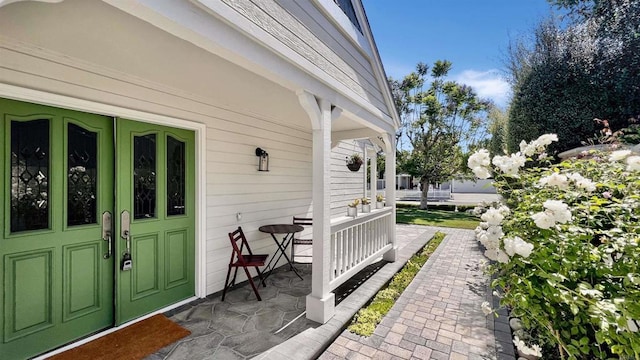 doorway to property featuring covered porch