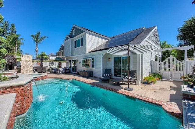 41 Baroness Ln, Laguna Niguel, CA 92677 - back of property featuring a gate, roof mounted solar panels, a patio area, and fence