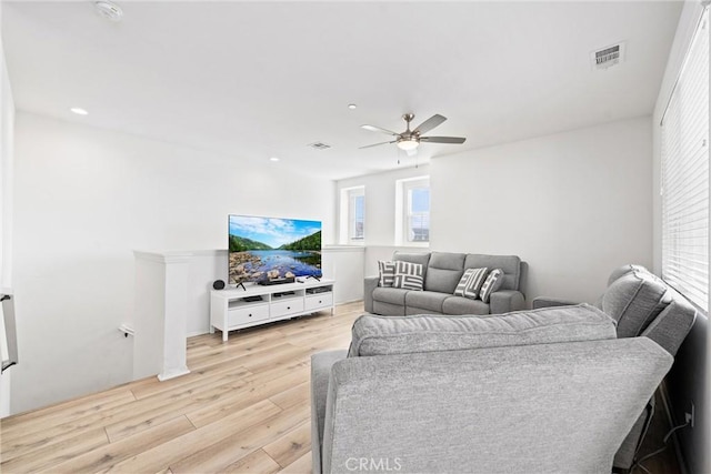 living area featuring light wood-type flooring, ceiling fan, visible vents, and recessed lighting