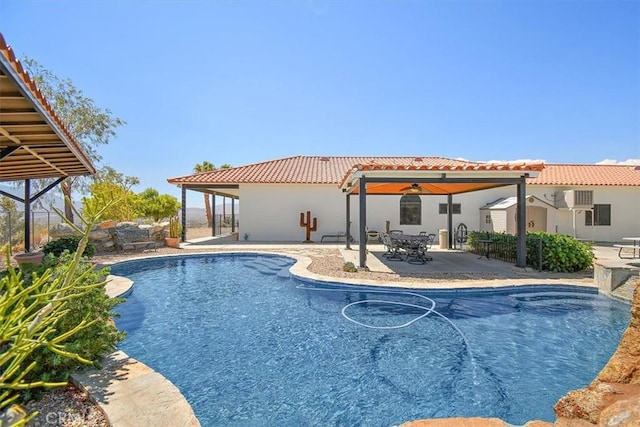 rear view of property featuring ceiling fan and a patio