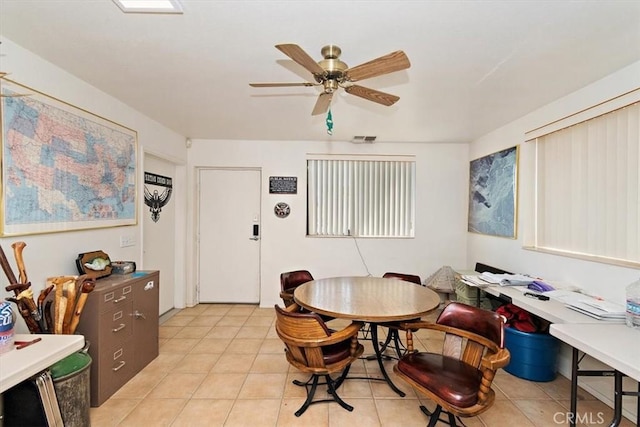 tiled dining area featuring ceiling fan