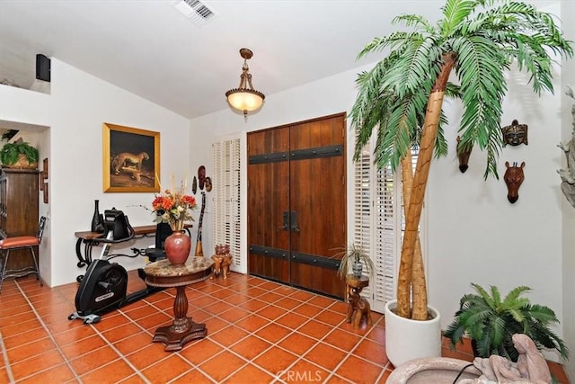 entrance foyer with tile patterned flooring and lofted ceiling