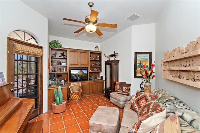 living room with ceiling fan and tile patterned floors