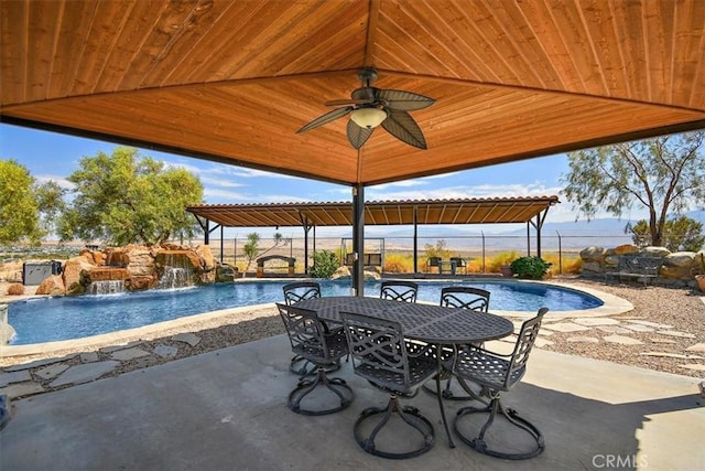 view of swimming pool featuring a patio, pool water feature, and ceiling fan