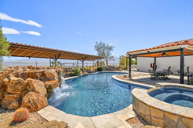 view of pool with a patio area and an in ground hot tub