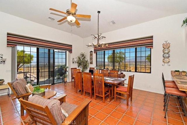 dining area with tile patterned flooring and ceiling fan with notable chandelier