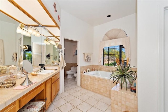 bathroom featuring a bidet, vanity, a relaxing tiled tub, tile patterned floors, and toilet