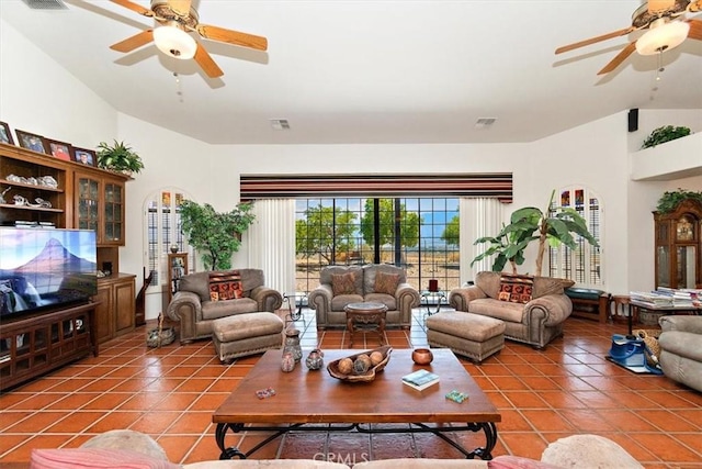 living room with vaulted ceiling, tile patterned floors, and ceiling fan