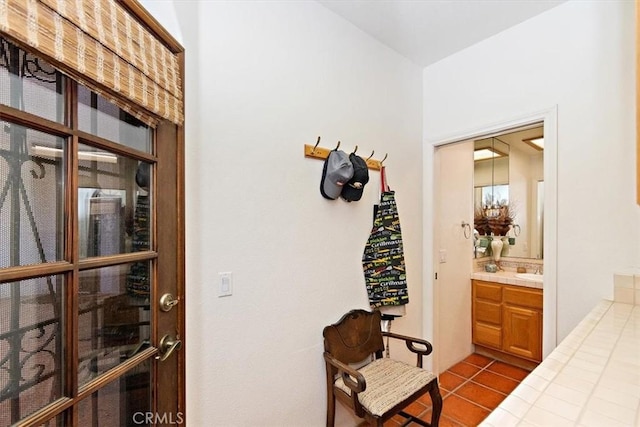 hallway featuring tile patterned floors and sink