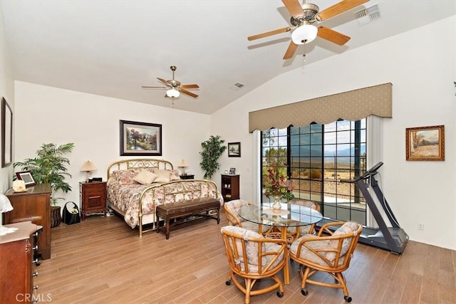 bedroom with vaulted ceiling and light hardwood / wood-style flooring