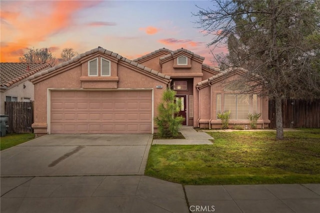 view of front of house with a garage and a yard