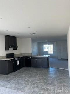 kitchen with open floor plan, light countertops, black range with electric cooktop, and a peninsula