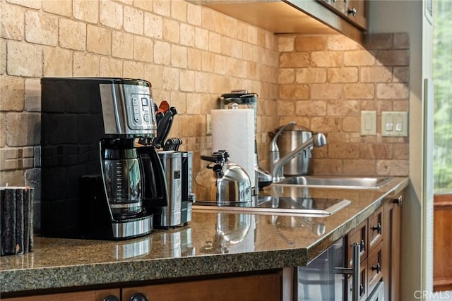 kitchen with sink and dark stone countertops