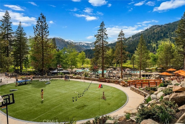 view of home's community featuring a mountain view and a lawn