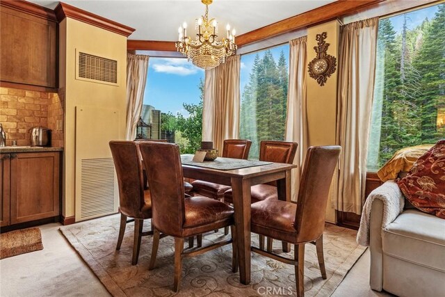 carpeted dining space with a chandelier