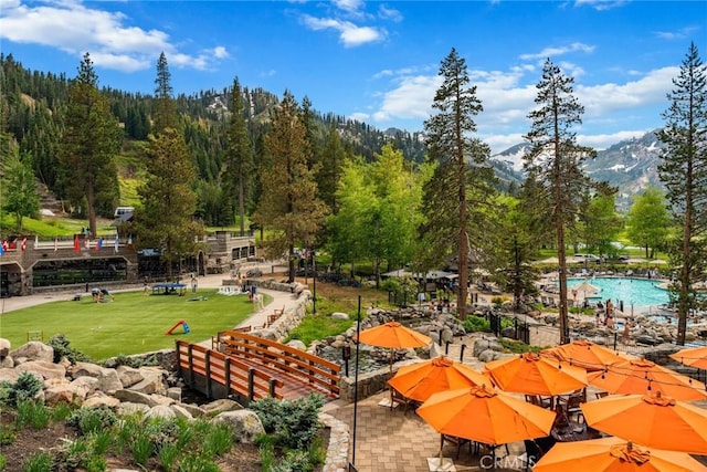 view of property's community featuring a yard and a mountain view