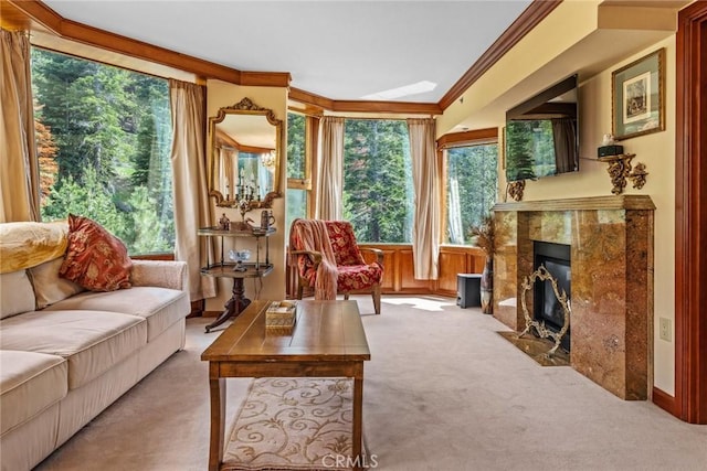 interior space with ornamental molding, light carpet, and a high end fireplace