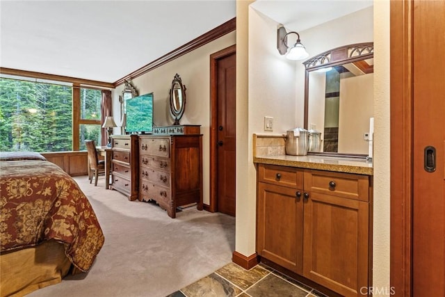 bedroom featuring crown molding and dark carpet