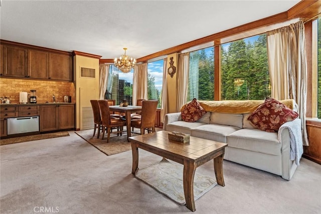 living room with light carpet and an inviting chandelier