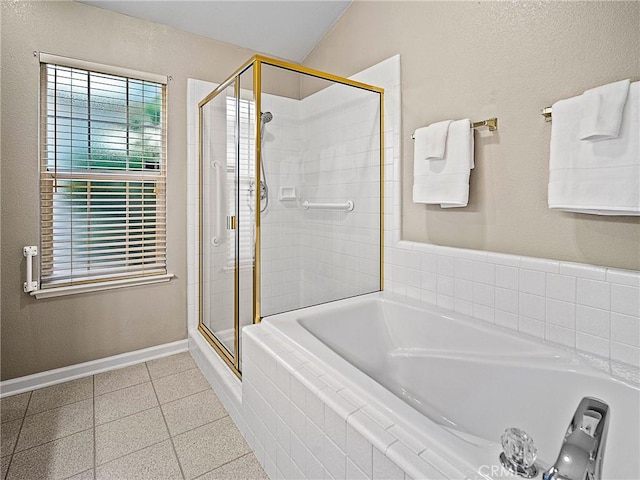 full bathroom featuring a bath, baseboards, and a stall shower