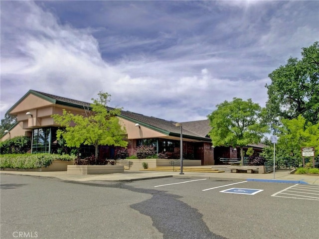 view of building exterior with uncovered parking