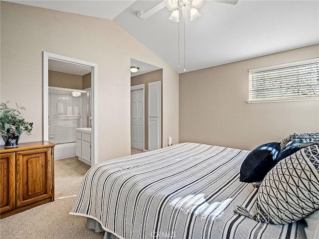 bedroom with light colored carpet, a ceiling fan, connected bathroom, and vaulted ceiling