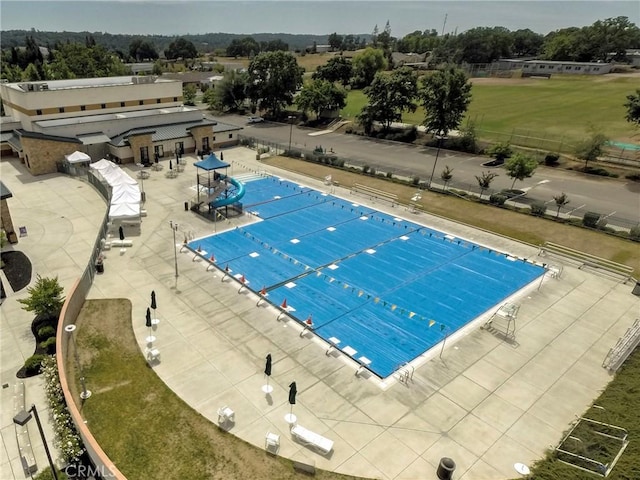 pool featuring a patio area and fence