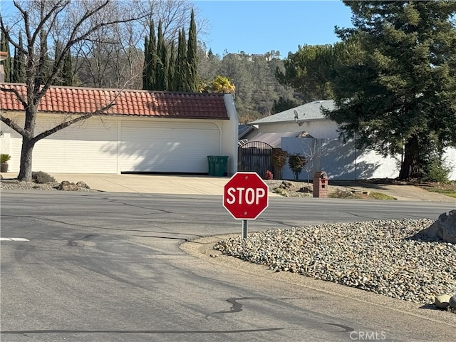 view of road with traffic signs and a gate