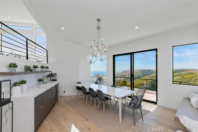 dining room with recessed lighting, baseboards, light wood-type flooring, and a chandelier