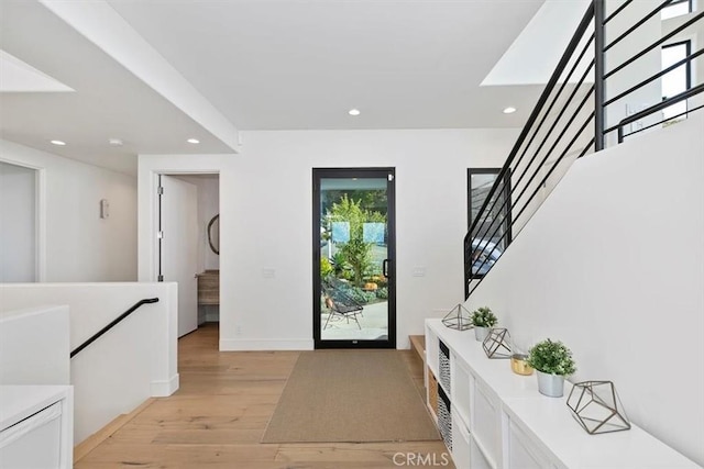 foyer entrance with light hardwood / wood-style flooring