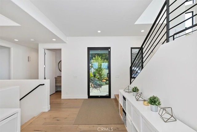 foyer entrance featuring stairs, recessed lighting, baseboards, and light wood finished floors