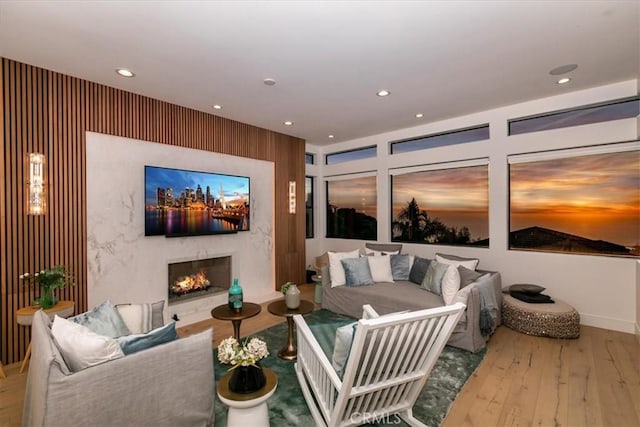 living room with hardwood / wood-style floors and a high end fireplace