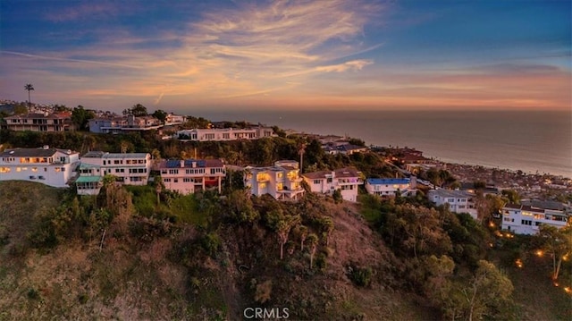 aerial view at dusk with a water view