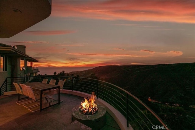 exterior space with an outdoor fire pit and a patio area