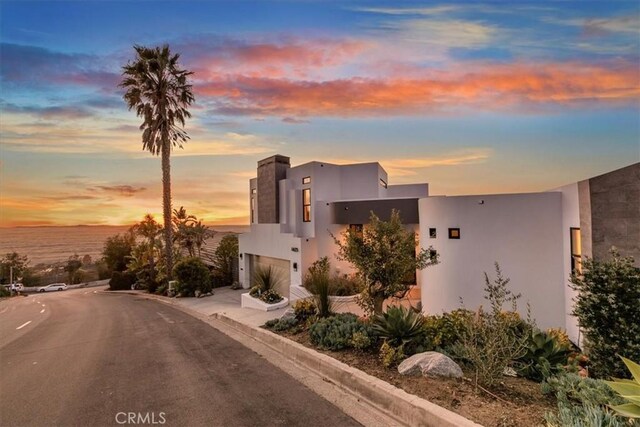 modern home with stucco siding, concrete driveway, and a garage