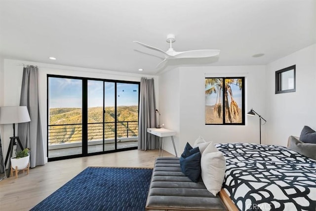 bedroom with ceiling fan, access to exterior, and light hardwood / wood-style floors