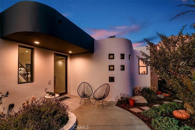 exterior space with a patio area and stucco siding