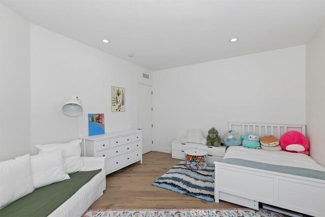 bedroom with recessed lighting, light wood-style flooring, and visible vents