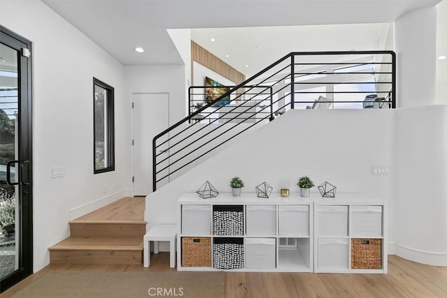 stairs featuring baseboards, recessed lighting, and wood finished floors