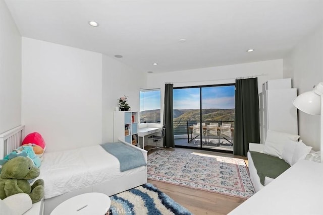 bedroom featuring access to outside, recessed lighting, and wood finished floors